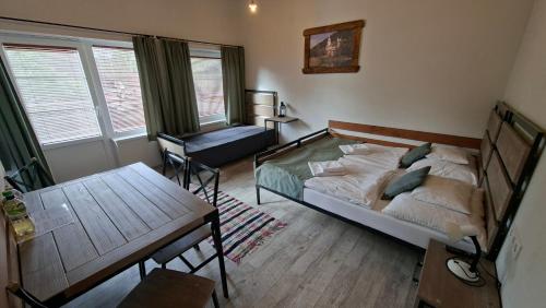 a bedroom with a bed and a desk and a chair at Zamárdi Trafóház in Zamárdi