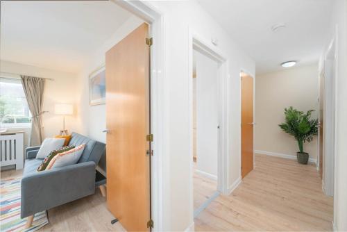 a living room with a blue couch and a sliding door at Aberdeen 2BR Flat Near Airport & City Centre in Aberdeen