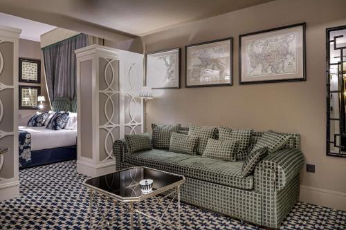 a living room with a couch and a bed at NH Collection Colón Valencia in Valencia