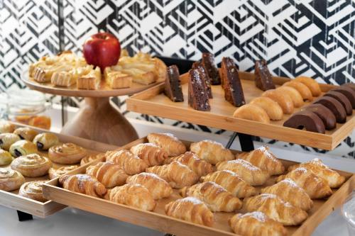 a display of different types of pastries and desserts at NH Collection Colón Valencia in Valencia