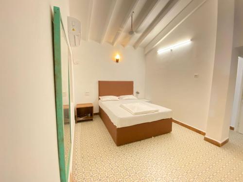 a bedroom with a bed and a mirror at Beach Touch 4 Bedroom Modern Villa with Plunge pool by "Dreme 100 BnB" in Morjim