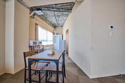 a dining room with a table and chairs at ホステル サクヤ in Fujiyoshida