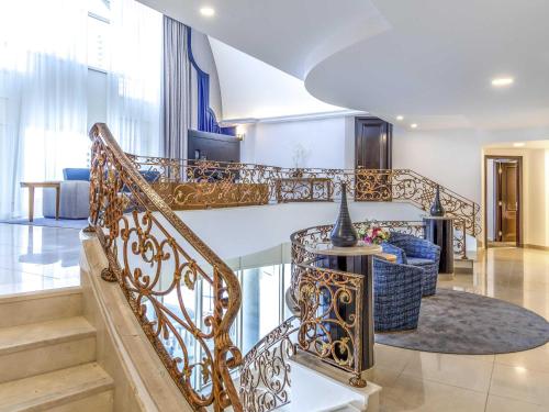 a staircase in a house with a lobby at Swissôtel Al Murooj Dubai in Dubai