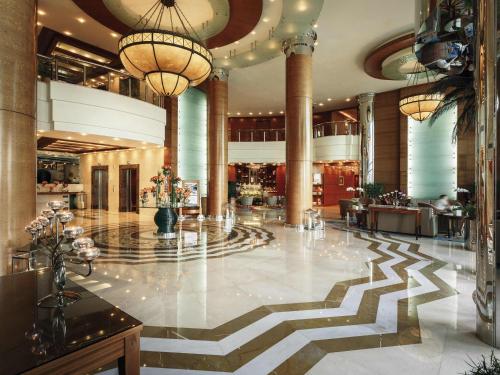 a lobby of a hotel with a zebra patterned floor at Swissôtel Al Murooj Dubai in Dubai