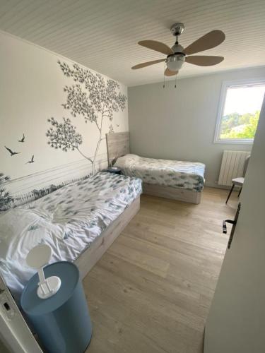 a bedroom with two beds and a ceiling fan at Villa de l'oustaoun in Sanary-sur-Mer