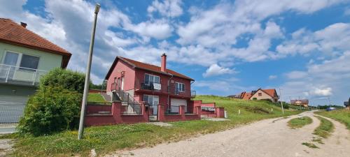 an old house on a hill next to a dirt road at Villa Venezia in Egerszalók