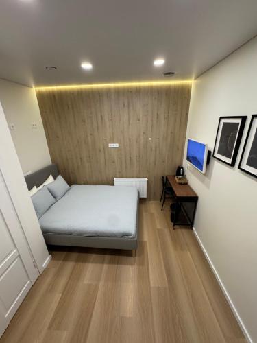 a small bedroom with a bed and a desk at 12 New Airport Apartment in Pakopi