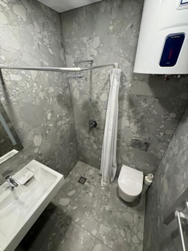 a bathroom with a sink and a toilet at 12 New Airport Apartment in Pakopi