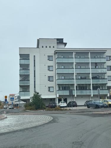 a large building with cars parked in front of it at Luxury Living in Rovaniemi