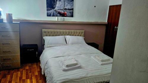 a bedroom with a bed with two towels on it at old Gomi iin in Tbilisi City