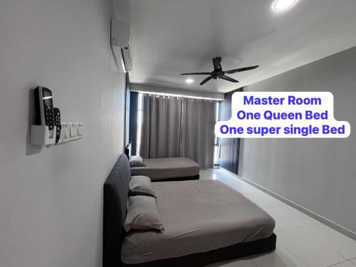 a room with three beds and a sign on the wall at LC Paragon Apartment in Labuan