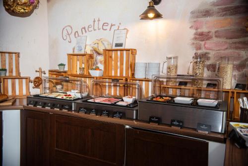 a buffet line with food on display in a restaurant at Hotel Perlach Allee by Blattl in Munich