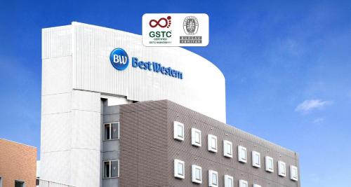 a building with a sign on the side of it at Best Western Osaka Tsukamoto in Osaka