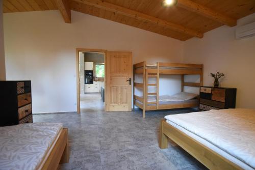 a bedroom with two beds and a bunk bed at Apartmán Farma Byzhradec in Dobruška