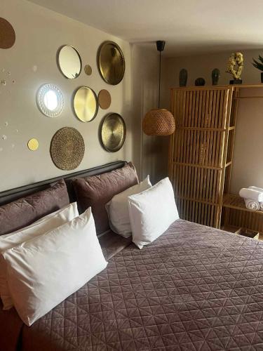 a bedroom with a bed with pillows and mirrors on the wall at Exclusive Del Mare Hotel in Sidari