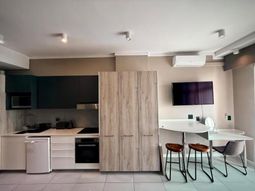 a kitchen with a wooden partition with a table and chairs at The Capital Trilogy Hotel in Pretoria