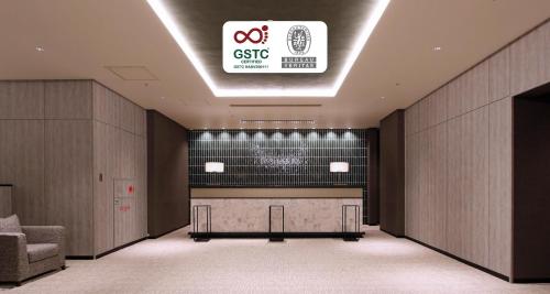 a lobby with a desk and a sign on the ceiling at Best Western Plus Nagoya Sakae in Nagoya