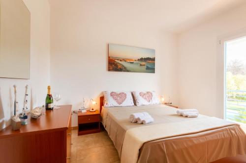 a bedroom with a bed with two towels on it at Dimora Riva Serena con Piscina in Torre Lapillo