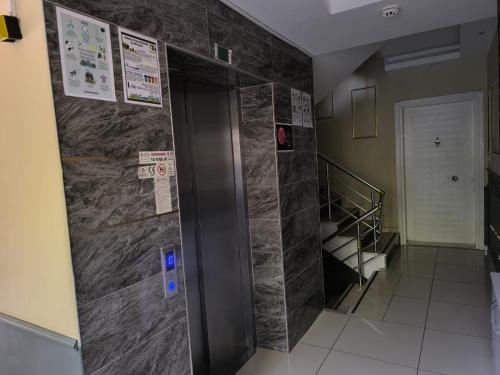 a elevator in a room with a wall of tiles at Hannapart Otel in Egirdir