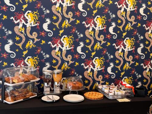 a table with pastries and other food items on a wall at Palazzo Sebeto in Naples