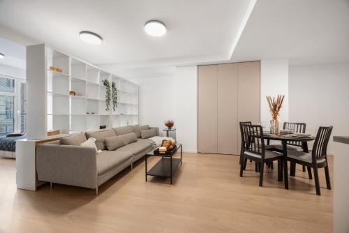 a living room with a couch and a table at LAM Cream Old Town Balcony & AC in Bratislava