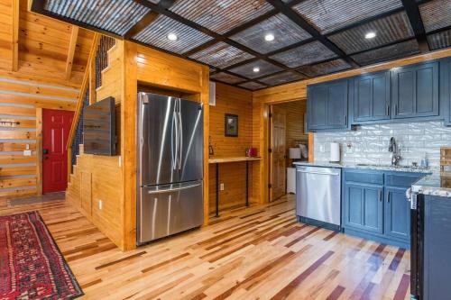 a kitchen with blue cabinets and a stainless steel refrigerator at Hot Tub & WiFi - Big Boulder - Red River Gorge KY in Rogers