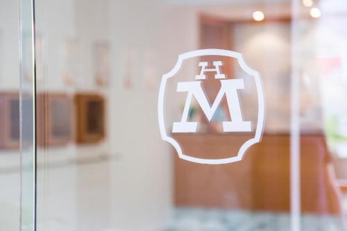 a maroon and white insignia on a glass window at Hotel Mara in Ortona