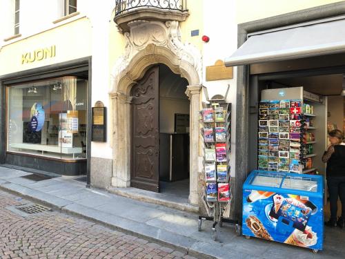 a store on a street with a building at Wonderful apartment in the historic center in Bellinzona