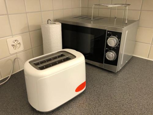 a microwave sitting on a counter next to a toaster at Wonderful apartment in the historic center in Bellinzona
