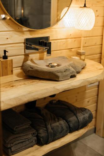 a bathroom with a sink and a mirror and towels at Forest Vibe Hotel&Spa in Kulʼchin