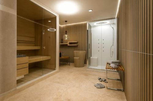 a bathroom with a walk in shower and a walk in closet at Incanto Relais & Charme - dBe Hotels in Florence