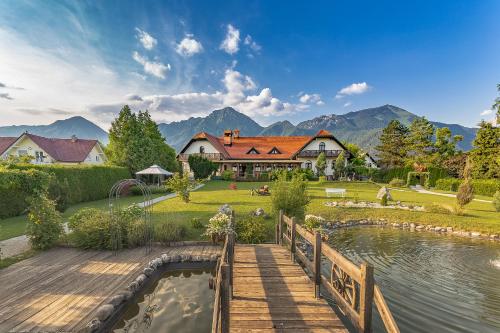 a house with a wooden bridge over a body of water at Glamping Bizjak in Preddvor