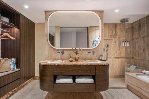a bathroom with a sink and a mirror at Dan Accadia Herzliya Hotel in Herzelia 