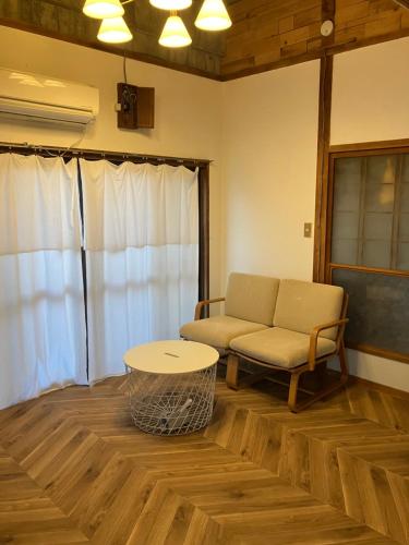 志摩市にあるお宿イヌとネコとのソファとテーブルのあるリビングルーム