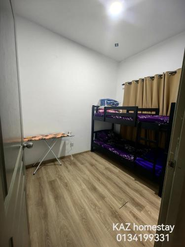 a room with two bunk beds and a wooden floor at KAZ homestay in Tanah Rata