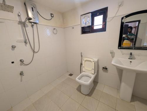 a bathroom with a toilet and a sink at Canopy villas in Mirissa