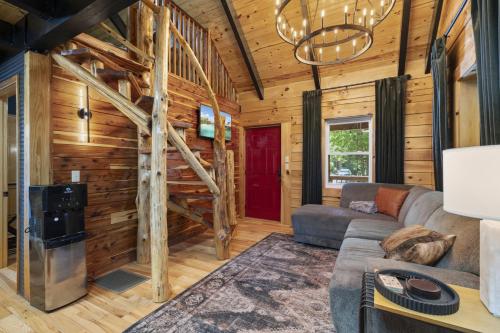 a living room with a couch and a red door at Hot Tub & WiFi - Hillside Haven Red River Gorge KY in Rogers