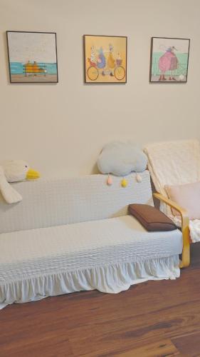 a bedroom with two beds and two pictures on the wall at 12A NEST Chatswood in Sydney