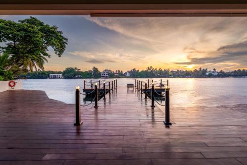 a dock with a bunch of boats on the water at NH Bentota Ceysands Resort in Bentota