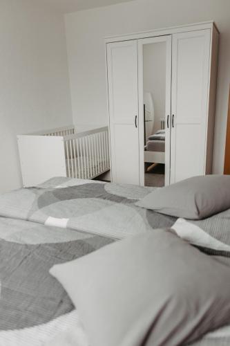 a bedroom with a large bed and a mirror at Ferienwohnung Maria in Herten