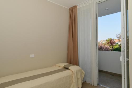 Giường trong phòng chung tại Moderno 3 camere con piscina Piazza Aurora