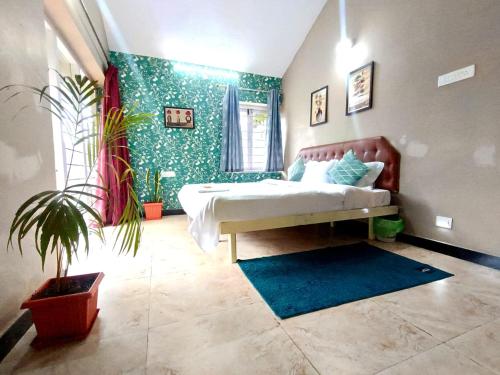a bedroom with a bed and a potted plant at QUEENS COTTAGE - individual cottage in Ooty