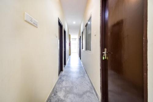 an empty corridor with a door at Hotel O Prayag in Jaipur