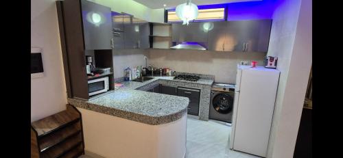 a kitchen with a white refrigerator and a stove at Thiam IMMO in Nouakchott