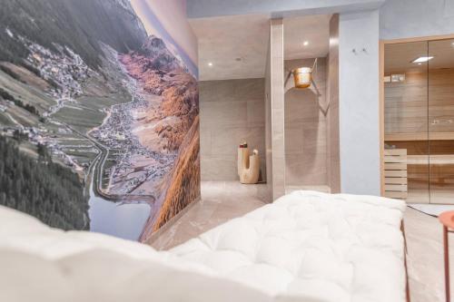 a bedroom with a large painting on the wall at Chalet Imbosc'chè 5 rooms Bnb in Livigno