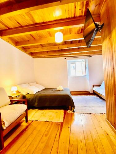 a bedroom with a bed and a couch in a room at Apartment in Coimbra Historical Center in Coimbra