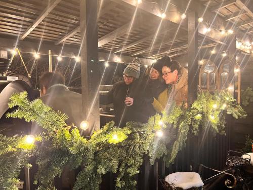 a group of people standing in a room with plants at 3-Rustic Escape, Firepit, BBQ & Pizza Oven in Pont Sticill