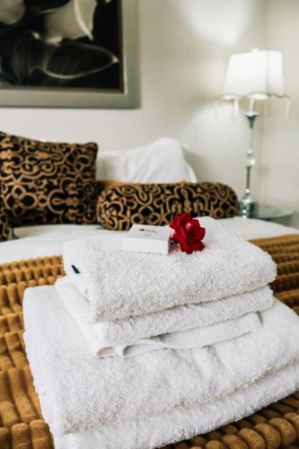a pile of towels sitting on top of a bed at Lamon Guesthouse in Kroonstad