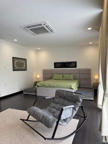 a bedroom with a bed and a chair in it at Micasa Bagan Laland,halal only in Tanjong Sepat