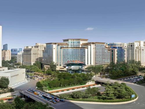 a city with a highway in front of tall buildings at Swissotel Beijing Hong Kong Macau Center - 1 min to subway in Beijing